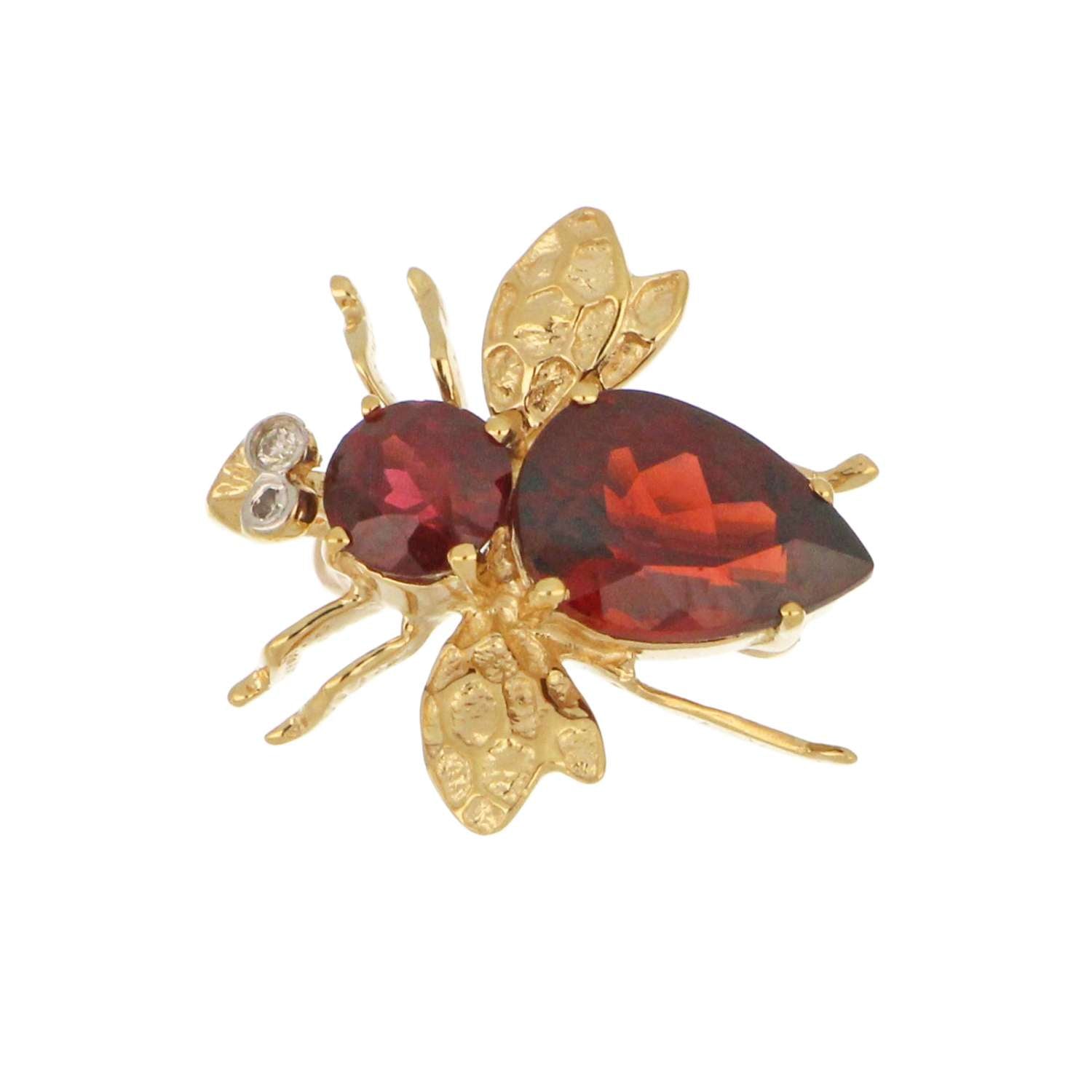 Close-up of 14kt yellow gold fly brooch showcasing garnets and single cut diamonds detailing