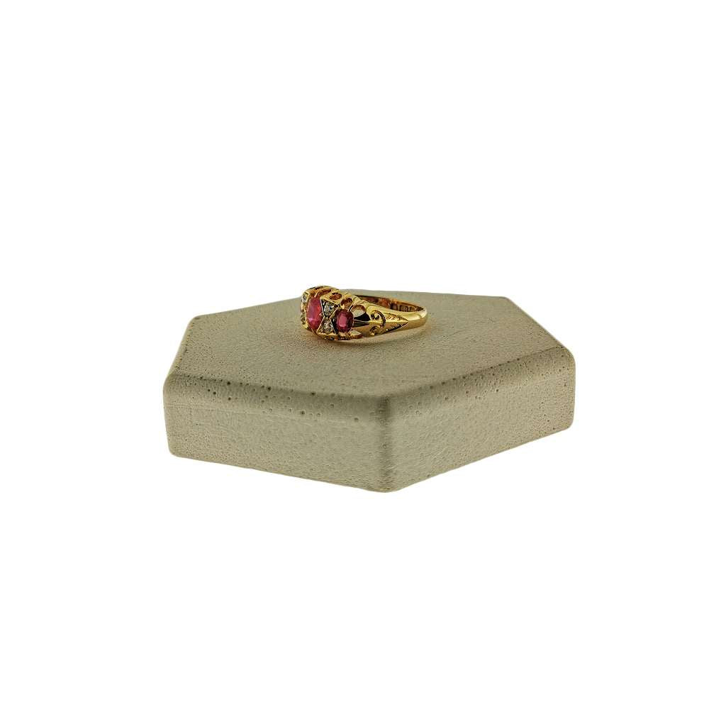 Side angle of 18kt yellow gold dinner ring highlighting intricate setting and gemstone arrangement