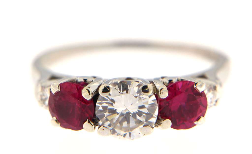 Close-up detail of claw setting for diamonds and rubies on 18kt white gold dinner ring