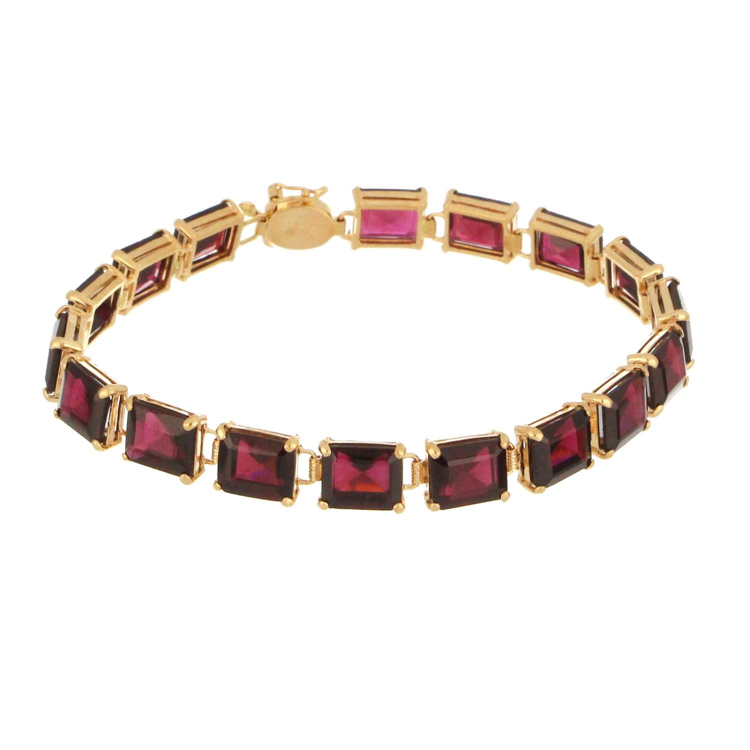 Close-up of 14kt yellow gold bracelet featuring deep red baguette cut garnet stones set in claw settings, weight 14.44 grams