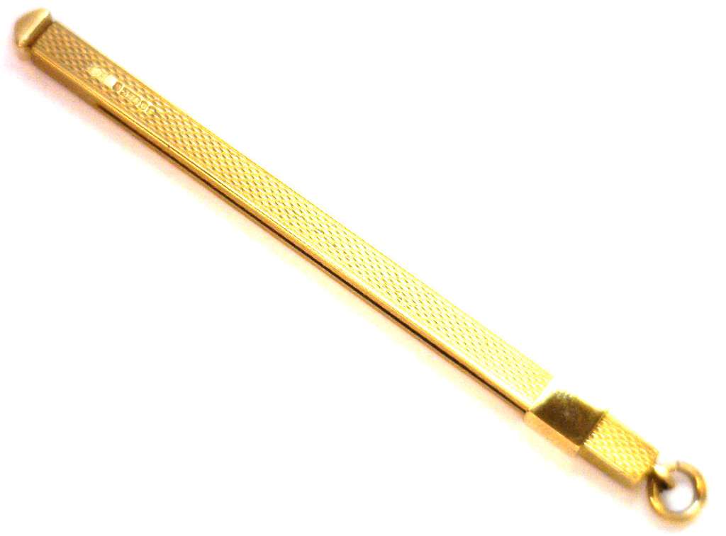 Close-up detail of 9kt yellow gold stir tool style pendant highlighting craftsmanship and texture