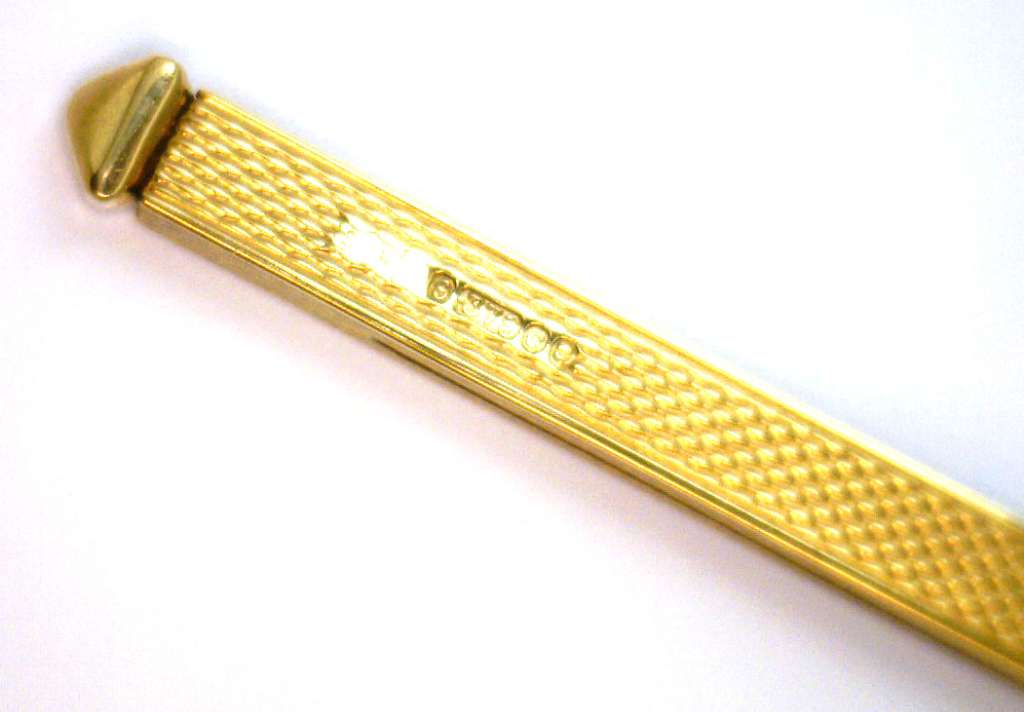 Side view of 9kt yellow gold pendant showcasing length and thickness, estimated 3 inches