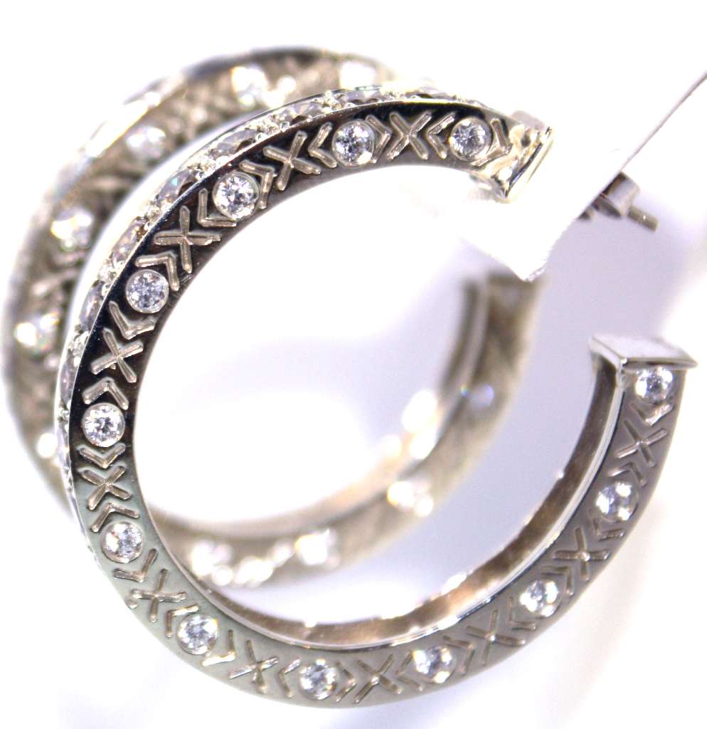 Side angle of 18kt white gold diamond hoop earrings highlighting the diamond arrangement and polished finish, total weight 25.61 grams