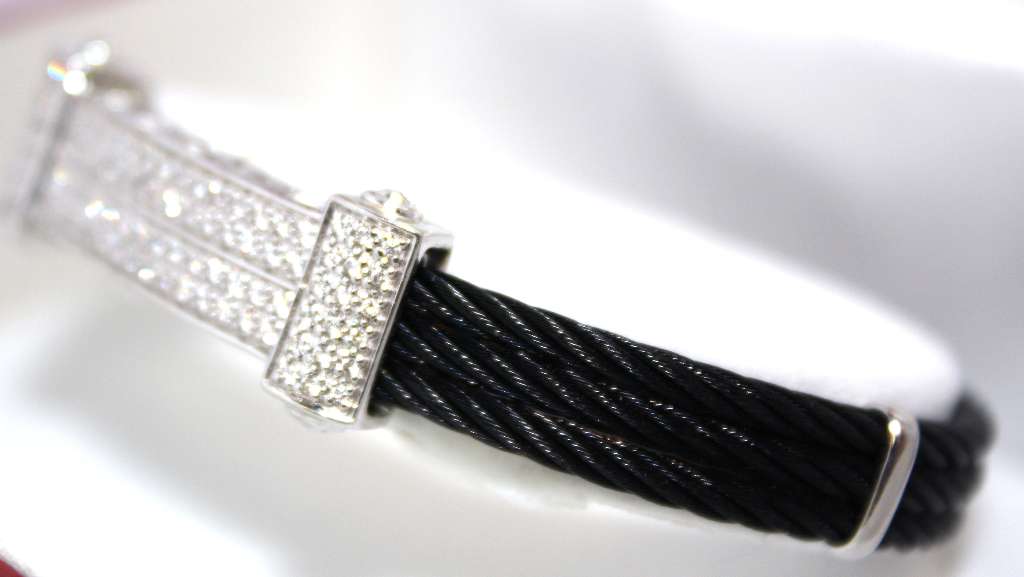Angle showing full length of 18kt white gold bracelet accented with black coated iron wire and 96 diamonds
