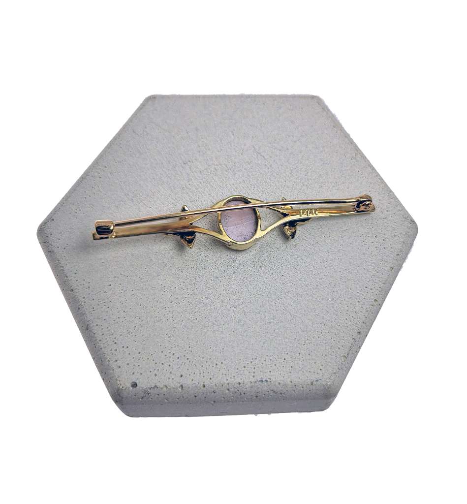Side angle of antique 14kt yellow gold cameo brooch highlighting fine craftsmanship and seed pearl embellishments