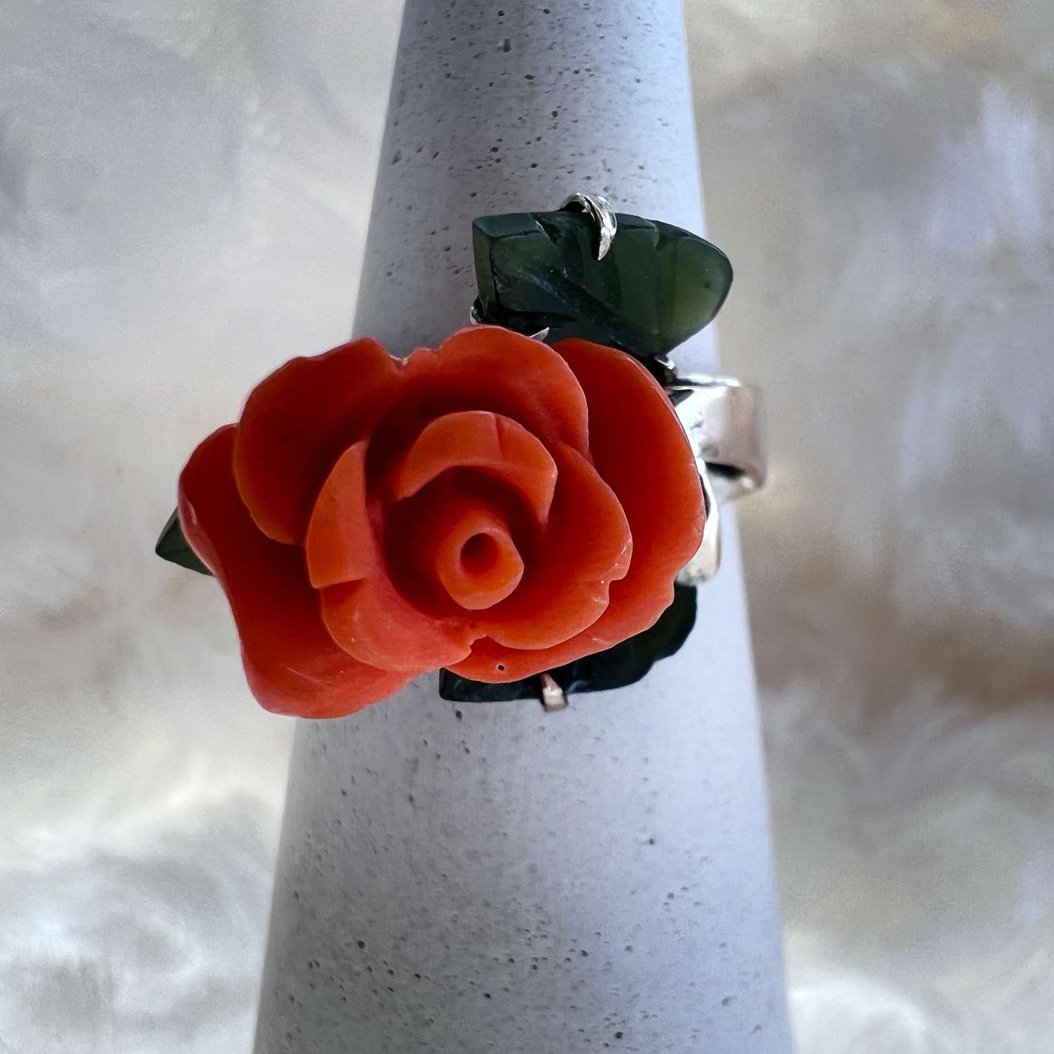 9kt yellow gold ring with pink coral carved rose flower and 3 BC jade leaves, front angle showing floral design