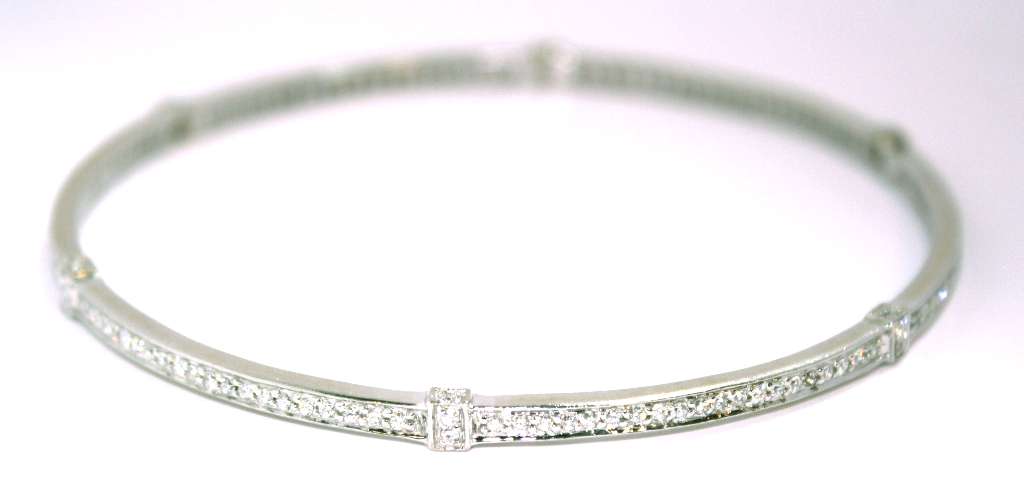 Detailed view of diamond arrangement on 18kt white gold bangle, total 1.44 cttw diamonds