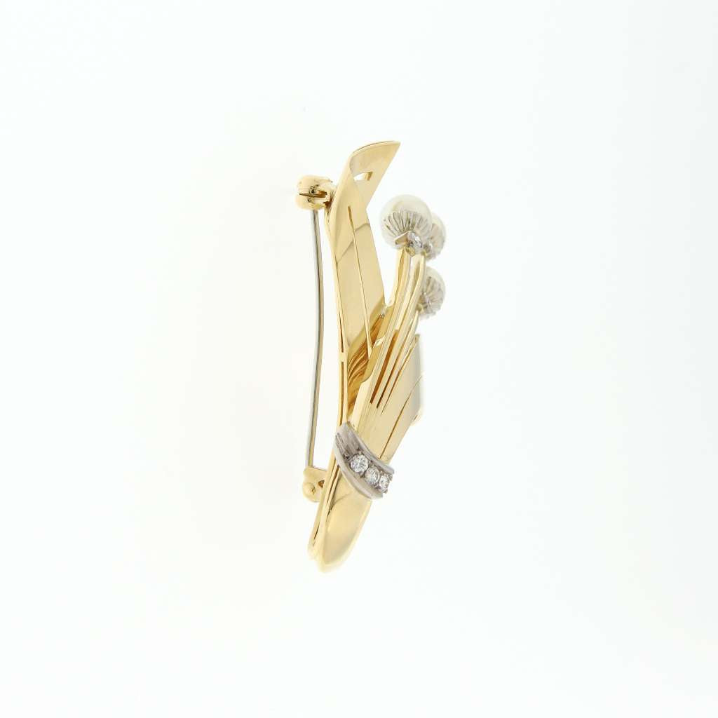 Close-up angled view of the 18kt yellow and white gold brooch featuring pearl and diamond detailing