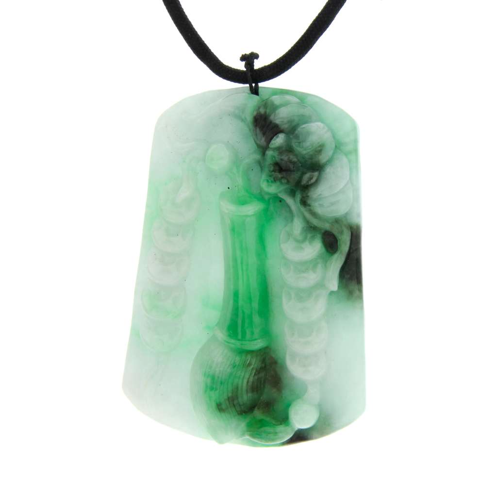 Back side close-up showing intricate carving of bat motif on Burmese double-sided jadeite pendant