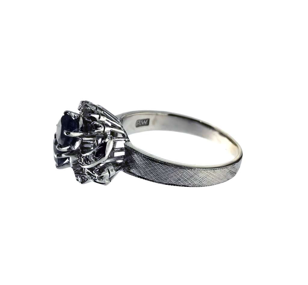 Close-up side profile of 40% silver ring featuring two 5x5mm round blue sapphires and 20 small round diamonds