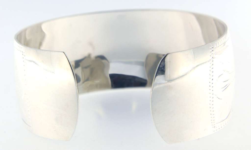 Detailed close-up of sterling silver bangle edges and smooth surface
