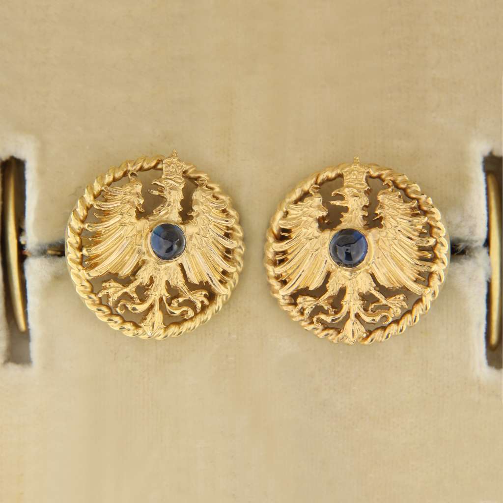14kt and 18kt yellow gold men's cufflink set featuring cabochon-cut blue sapphires each approximately 4mm, angled top view, total weight 12 grams