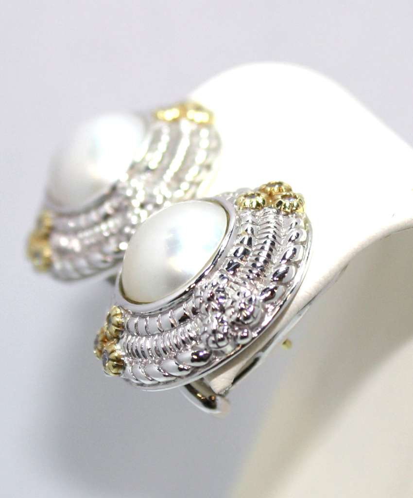 Side angle of pearl stud earrings with omega backings highlighting 18kt yellow gold and sterling silver materials
