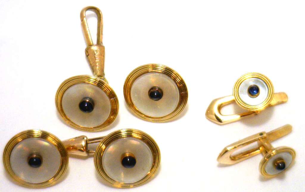 14kt yellow gold cufflink set with white mother-of-pearl and cabochon blue sapphires, front angle showing elegant design