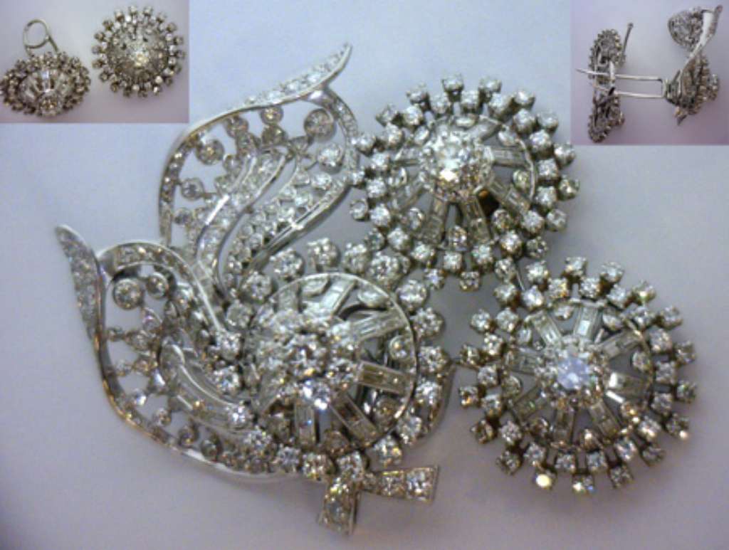 Antique Victorian style platinum diamond brooch showing flower motif with central round brilliant diamonds