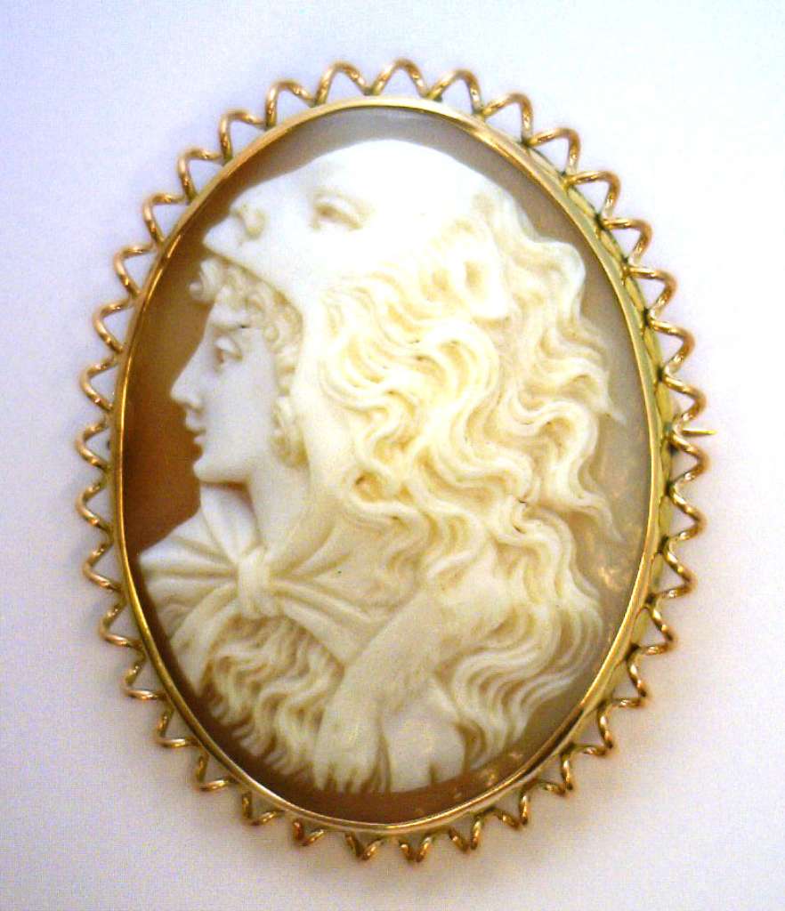 9kt yellow gold cameo brooch showcasing oval shell cameo motif in warm yellow gold, front angle view
