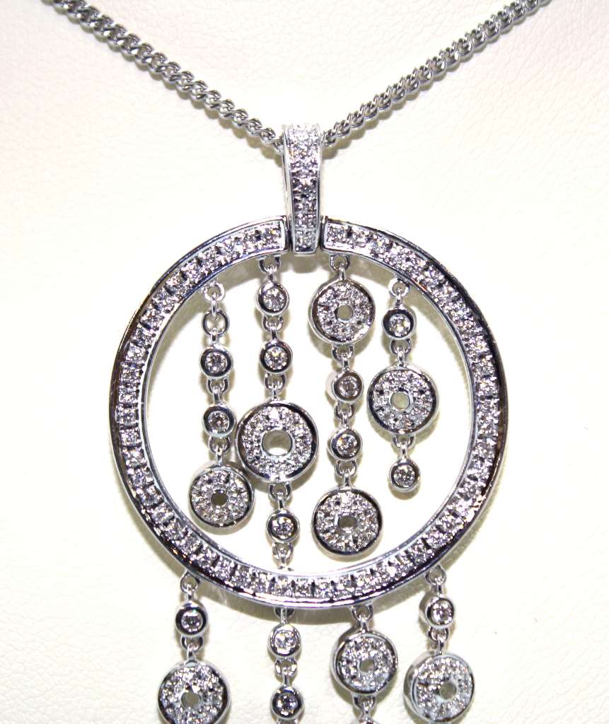 Close-up angle showing sparkling VS clarity G-H color diamonds set on 18kt white gold pendant