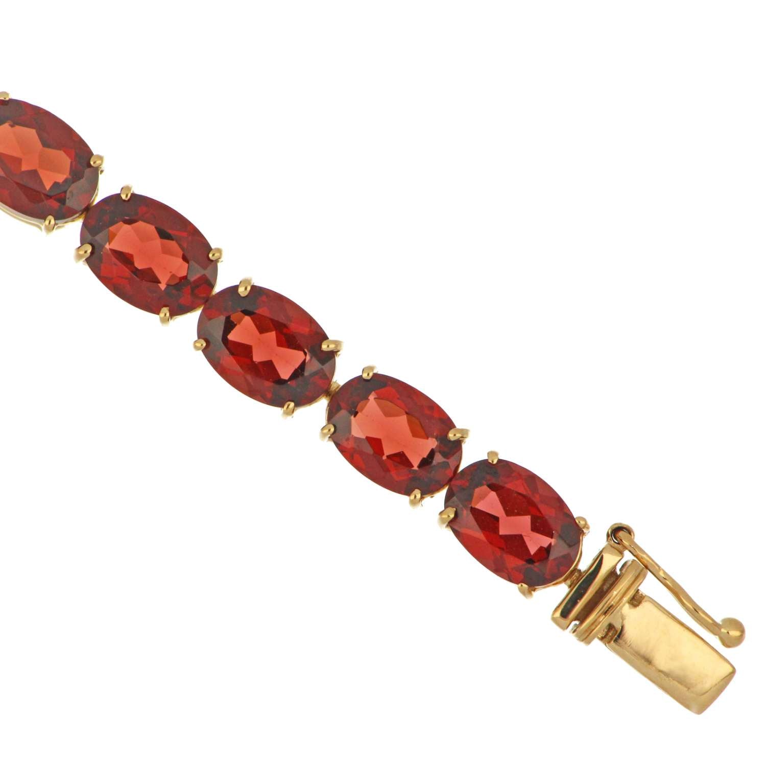 Side angle of 14kt yellow gold garnet bracelet showing oval garnets and clasp detail