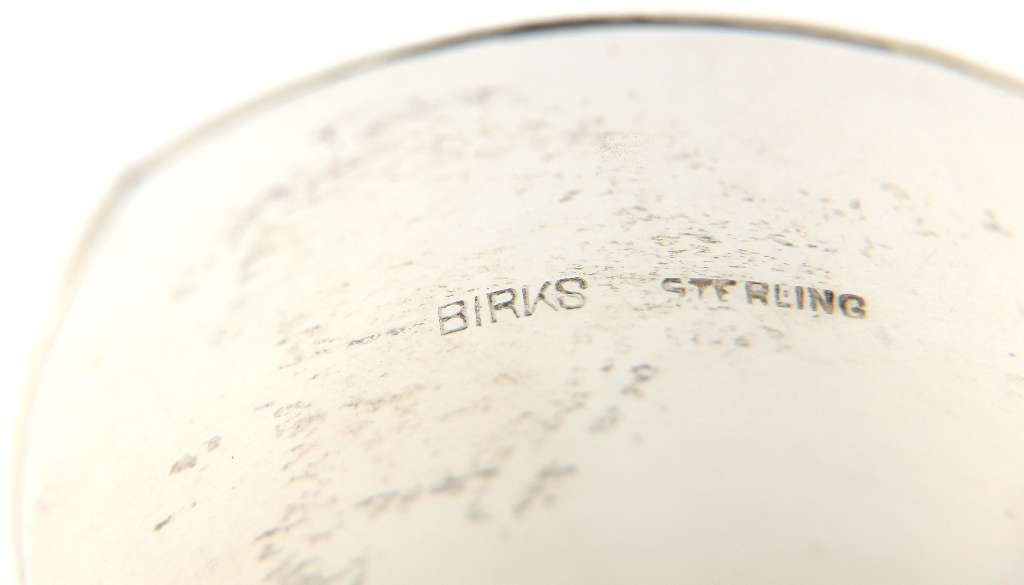 Sterling silver open-end bangle shown on white background highlighting shiny finish