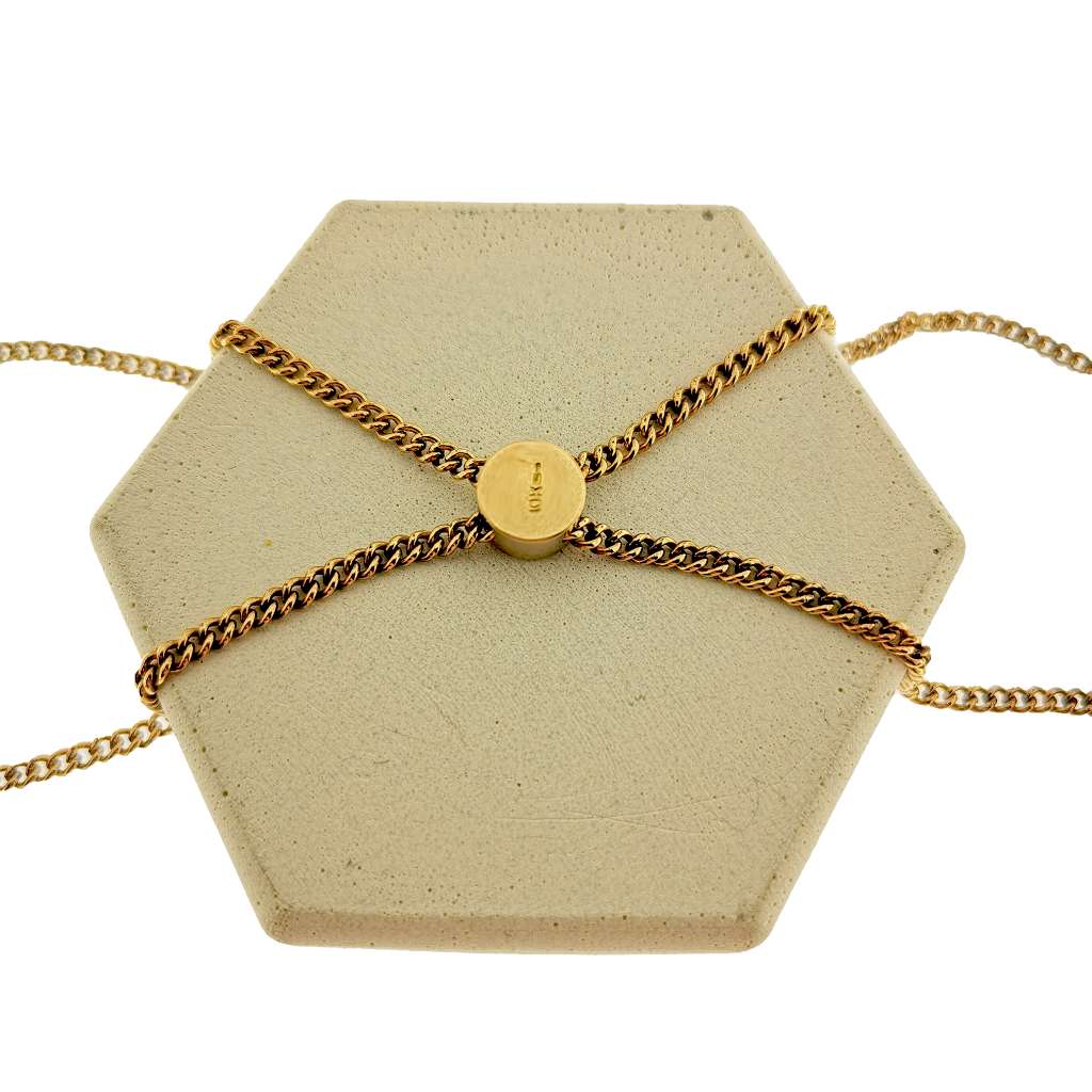 Close-up of 10kt yellow gold curb link chain segment highlighting the sliding charm adorned with lustrous seed pearls