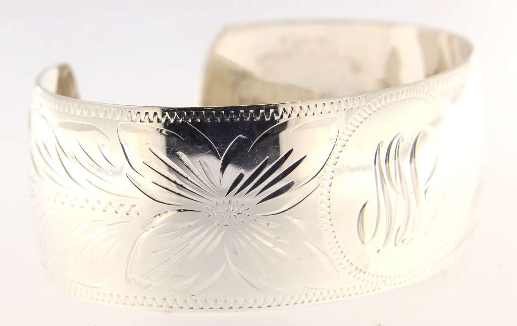 Top angle of sleek sterling silver open-end bangle emphasizing minimalist design