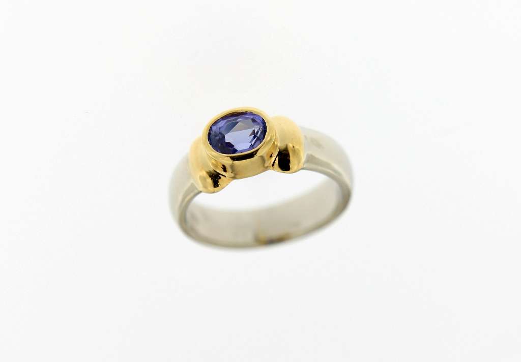 18K yellow and white gold ladies ring with oval purple tanzanite gemstone, front angle view