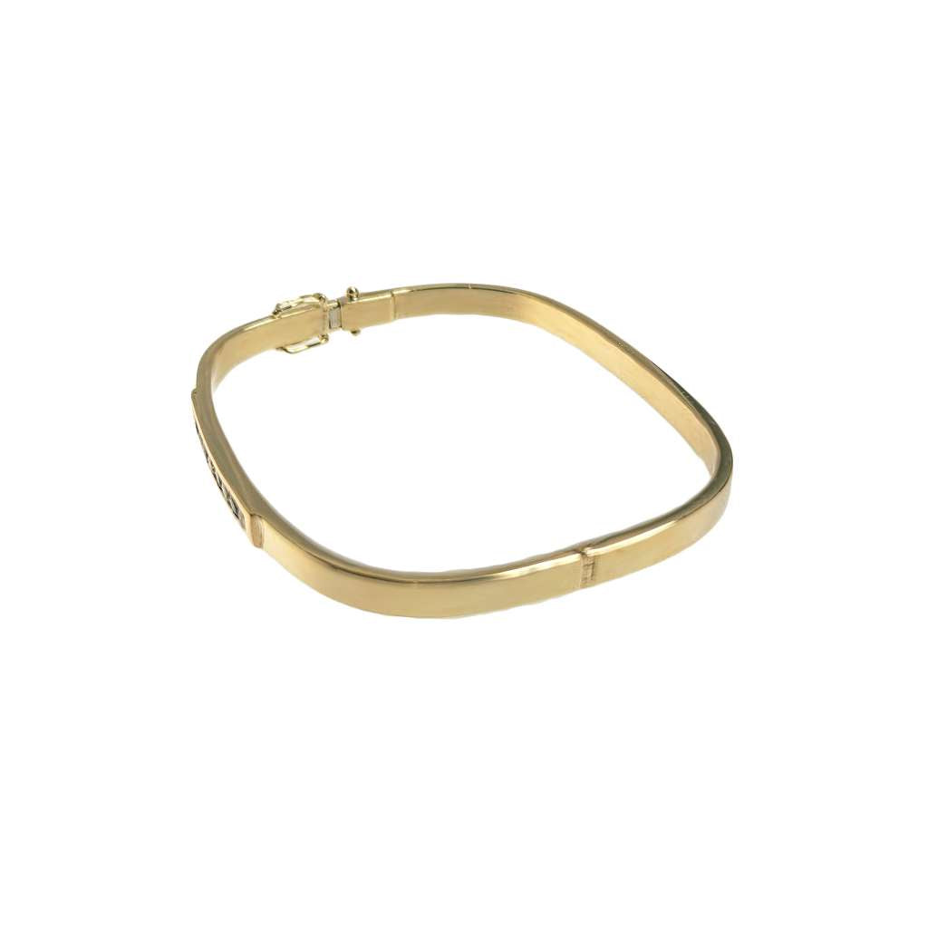 Close-up of yellow gold sapphire and diamond bangle highlighting soft square shape and sparkling stones
