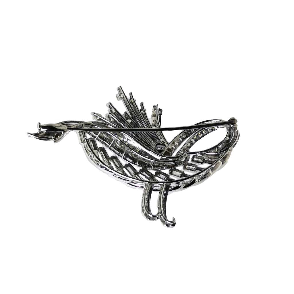 Top angle of vintage brooch showcasing 103 single and old European cut diamonds with filigree craftsmanship in silver and white gold
