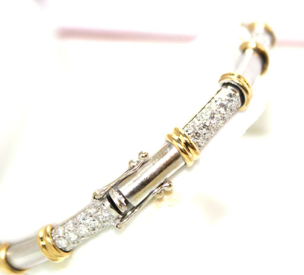 Elegant side view of 18kt gold bracelet displaying alternating white and yellow gold links with dazzling round diamonds