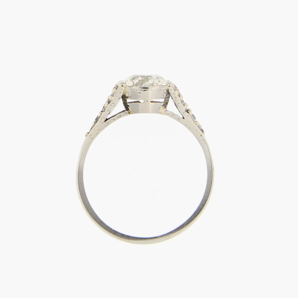 Top-down view of platinum ring highlighting old European cut center diamond surrounded by single cut diamonds