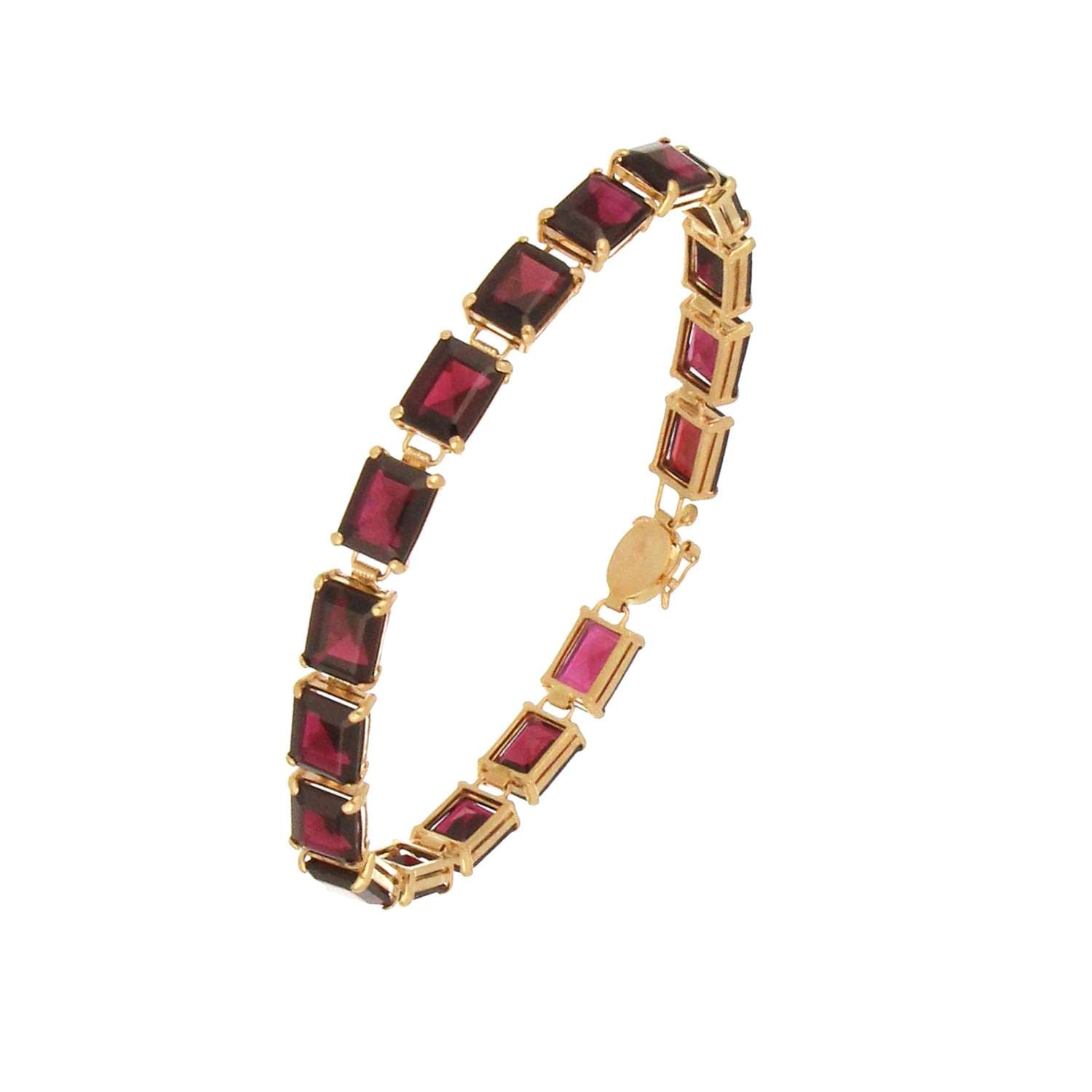 Detailed shot of baguette garnets on 14kt yellow gold bracelet, highlighting rich red hues and fine gold craftsmanship