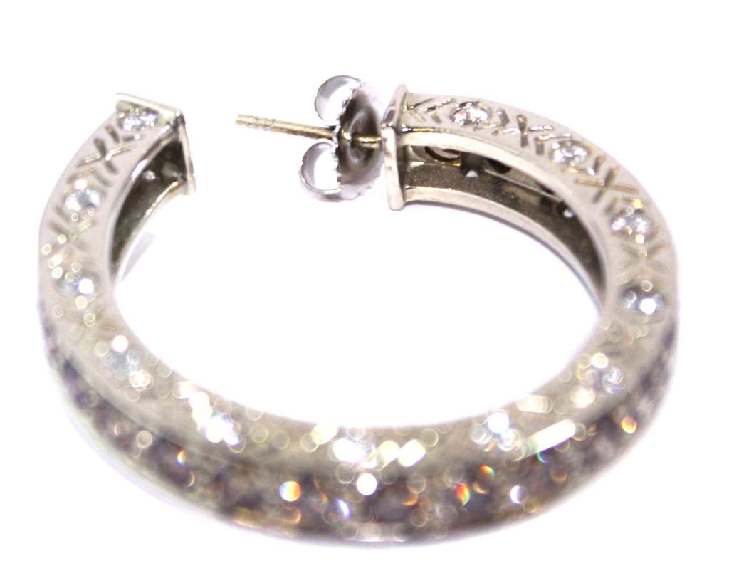 Front view of luxury 18kt white gold diamond hoop earrings featuring 94 round brilliant cut diamonds in brownish-orange and white hues