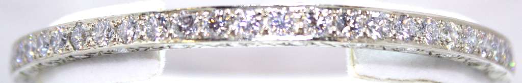Elegant 18kt white gold diamond bangle featuring 112 round brilliant cut diamonds with total weight approx. 12.6 cttw, top angle view