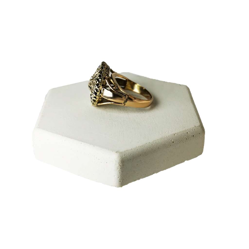 Side angle of 9kt rose gold and sterling silver antique ring displaying mixed metal design and vintage diamond setting