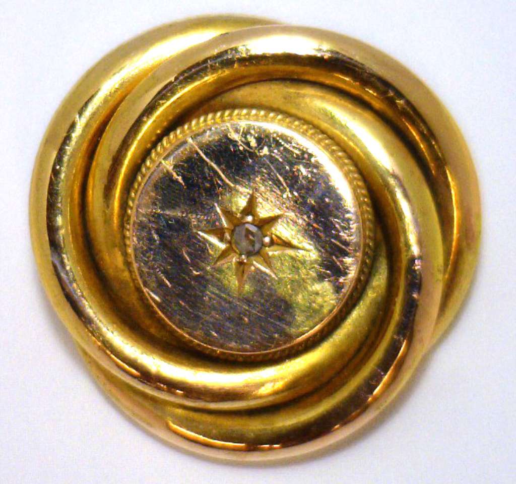 14kt yellow gold brooch with single small rose cut diamond, front angle displaying intricate design and gold shine