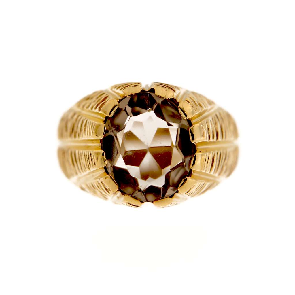 Close-up of oval smoky quartz set in polished 10kt yellow gold ring, side profile