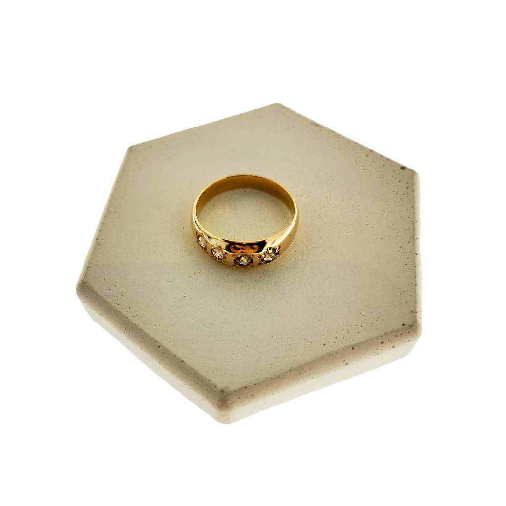 Side profile of 18kt yellow gold diamond band highlighting diamond placement and gold band thickness