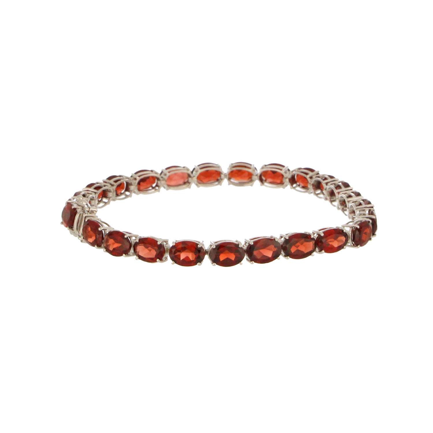 Close-up of 14kt white gold bracelet featuring 25 oval garnet stones set in claw settings, elegant design