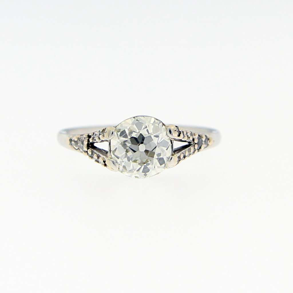 Side profile of platinum diamond ring showcasing elegant vintage design and diamond settings