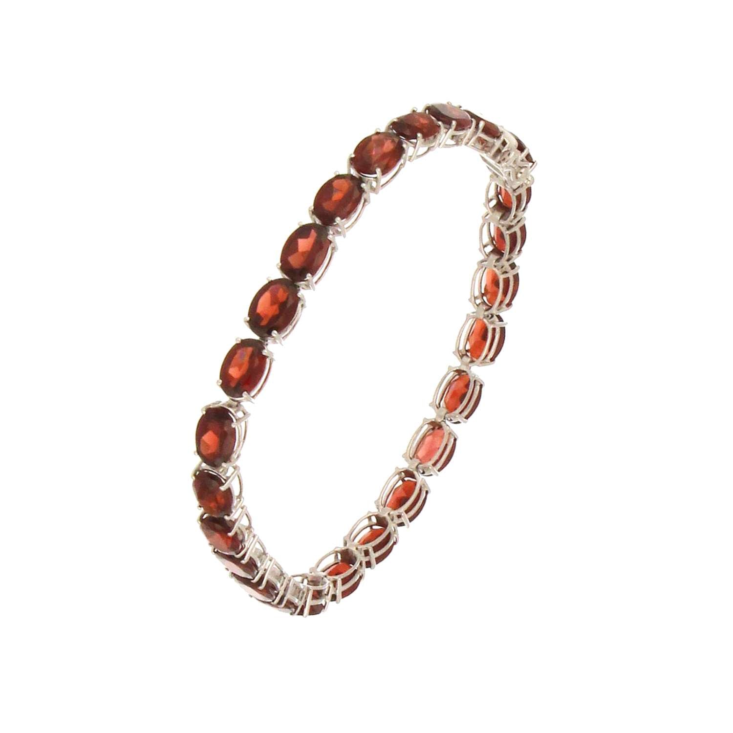 Full view of 14kt white gold bracelet with vibrant red oval garnet stones, lightweight and stylish