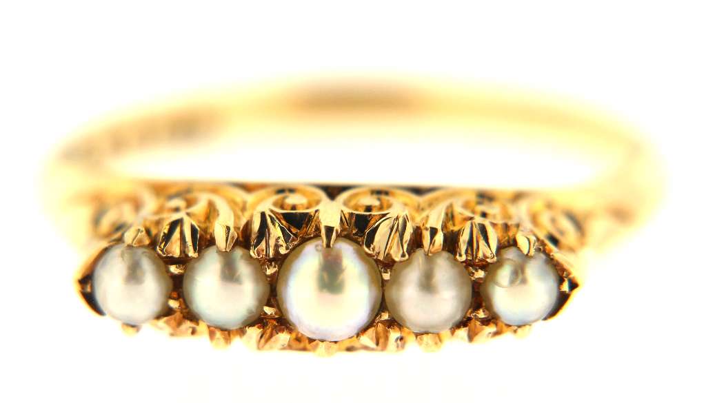 Angled view of elegant 14kt yellow gold ring showcasing pearl arrangement and smooth band, authentic fine jewelry