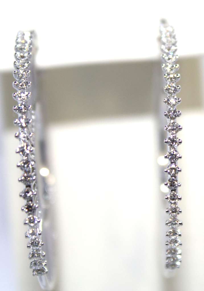 Side angle view of 18kt white gold diamond hoop earrings highlighting elegant hoop design and diamond setting