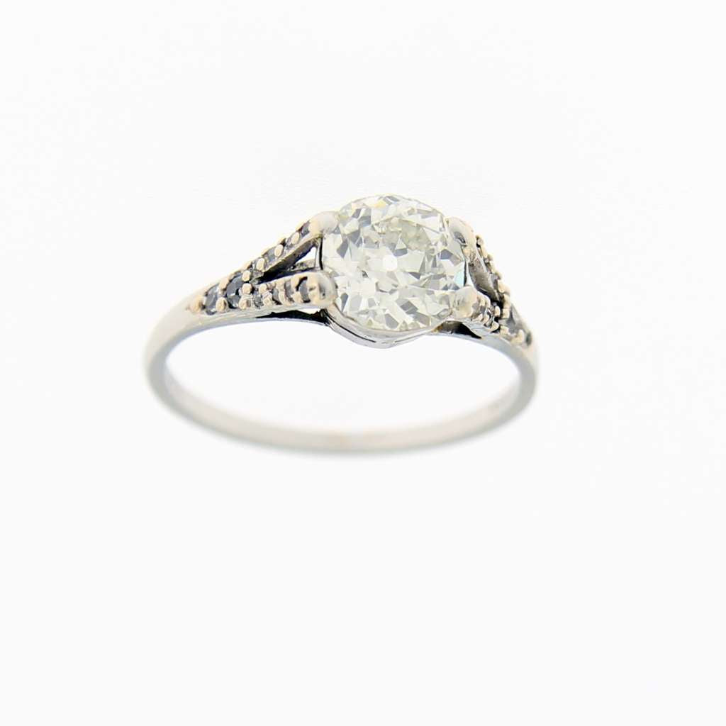 Close-up view of platinum old European cut diamond ring with prominent 1.20ct center diamond and surrounding 20 smaller diamonds