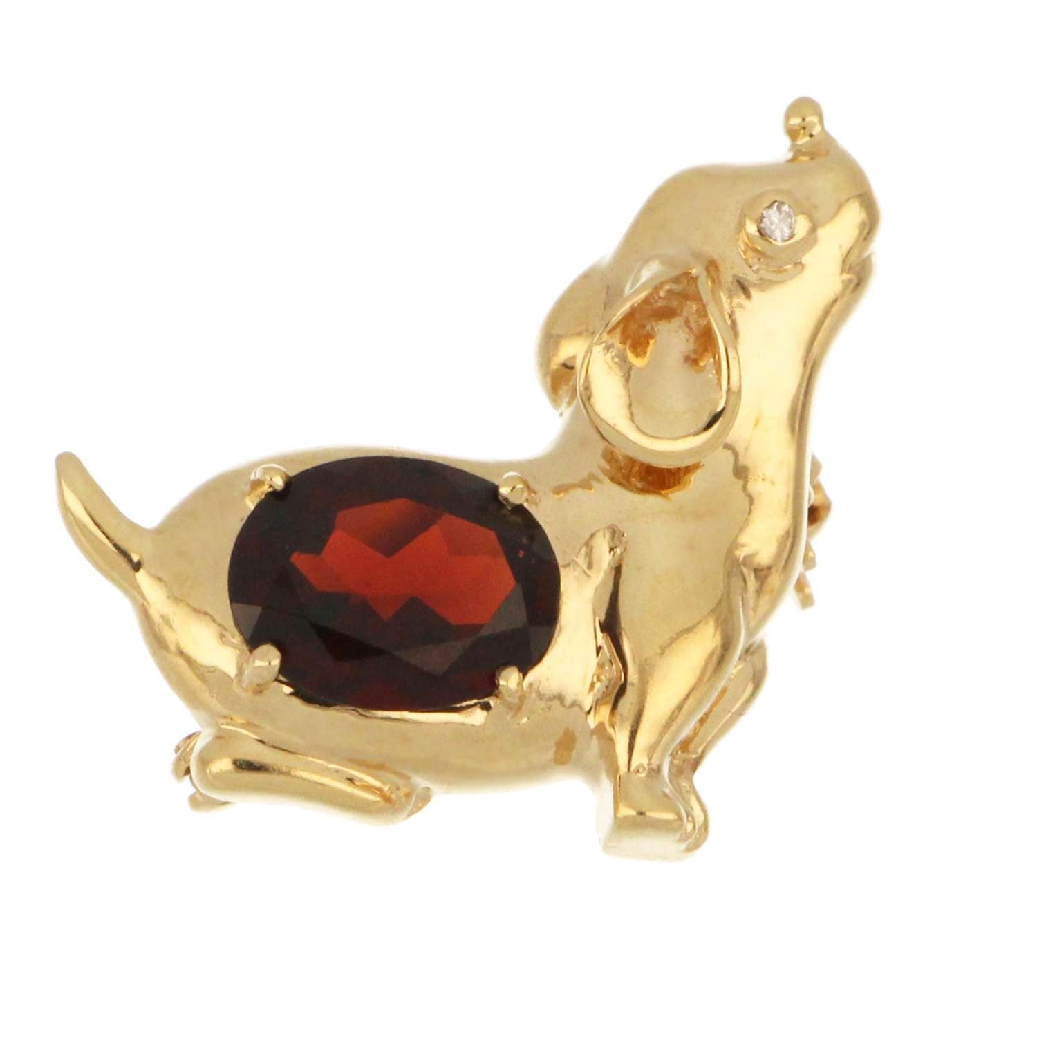 Close-up of oval garnet and full cut diamond set in 14kt yellow gold puppy brooch