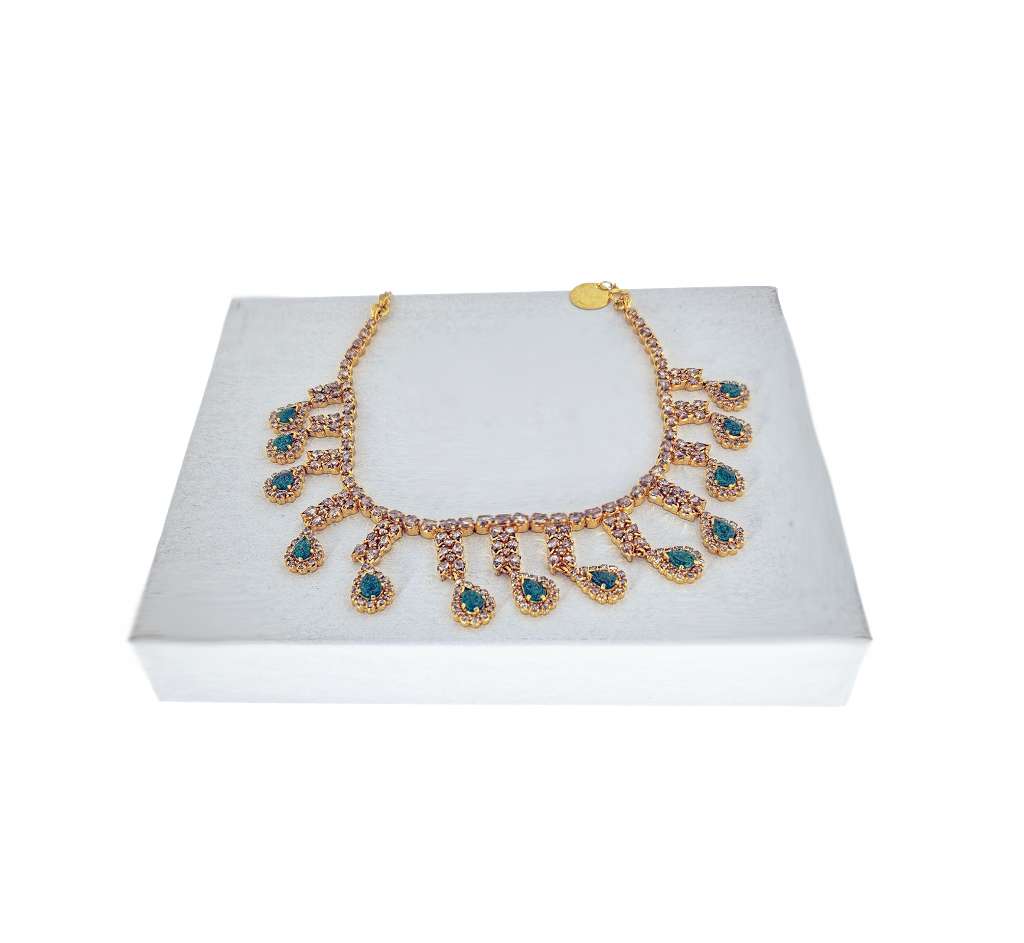 Side angle of antique 22kt yellow gold necklace showcasing diamond and emerald arrangement