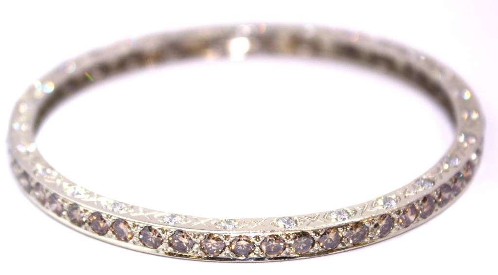 Detailed image of 18kt white gold bangle highlighting the sparkle of 56 brownish yellow and 56 white diamonds