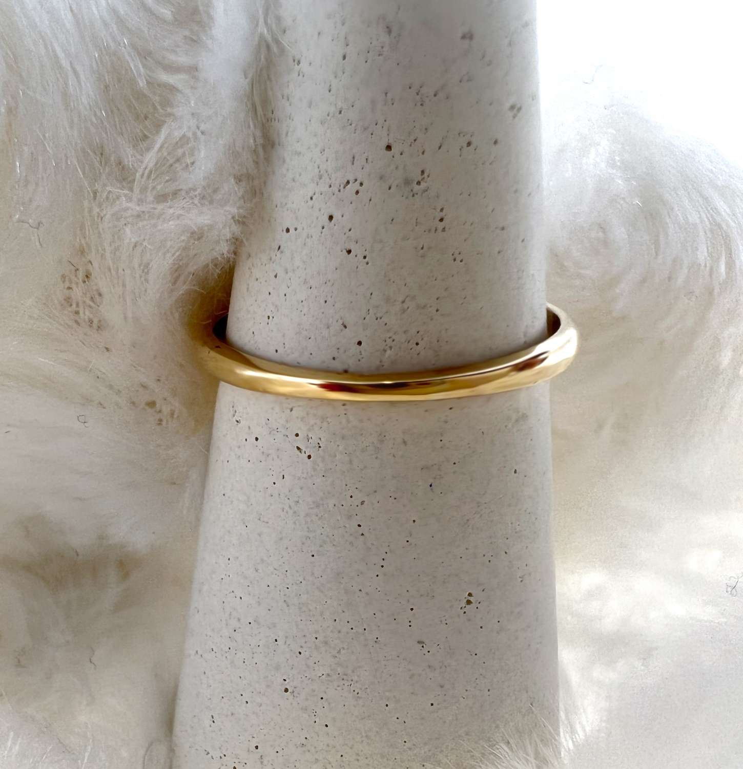 Detailed angle of yellow gold 18kt ring with round diamonds set in classic band style, weighing 2.93 grams
