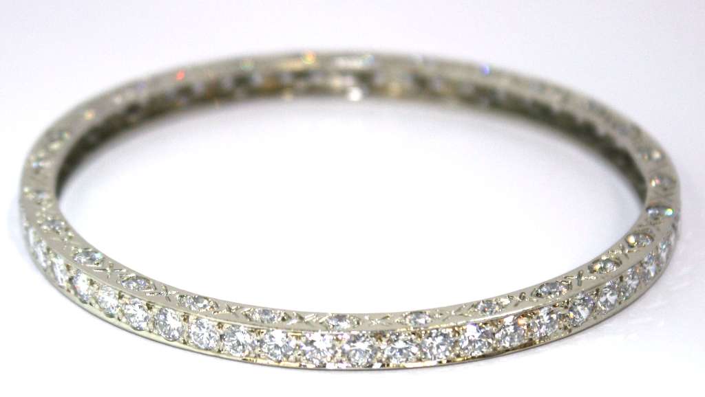 Full view of exquisite 18kt white gold diamond bangle with 112 round brilliant diamonds totaling approx 12.6cttw