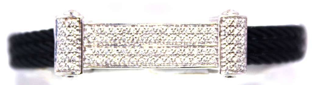 Close-up of 18kt white gold bracelet highlighting black coated iron wire and round brilliant cut diamonds