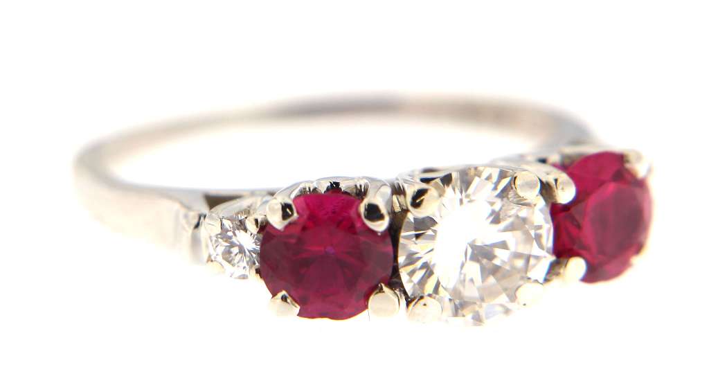 Top down view of 18kt white gold diamond and ruby dinner ring, weighing 2.85 grams, ring size 4.25